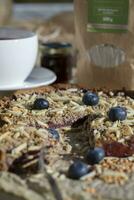 a slice of pie with blueberries and almonds on a table photo