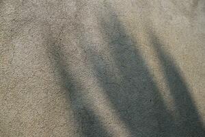 Sun shining on a cement wall background, grungy shiny wall surface, rusty cement wall backdrop photo