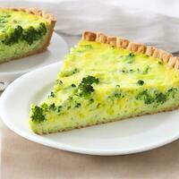 Broccoli quiche on a white plate. Shallow dof. Generative AI photo
