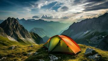 Camping in the mountains at sunset. The concept of active tourism photo
