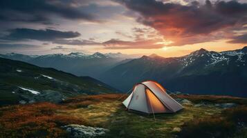 Camping in the mountains at sunset. The concept of active tourism photo