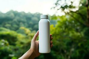 Hands holding a white bottle of whey protein on nature background photo