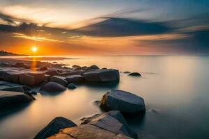 un puesta de sol terminado el Oceano con rocas y agua. generado por ai foto