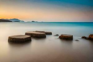 the beach at sunset with rocks in the water. AI-Generated photo