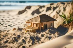a miniature house on the beach with sand and ocean. AI-Generated photo