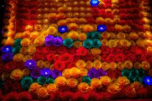 a colorful wall made of paper flowers. AI-Generated photo