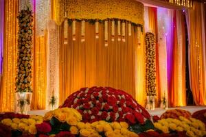 a wedding stage decorated with flowers and garlands. AI-Generated photo