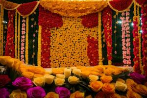 a colorful wedding stage with flowers and garlands. AI-Generated photo