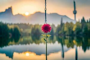a flower hanging from a chain in front of a lake. AI-Generated photo