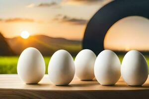 five white eggs are lined up on a table with a sunset in the background. AI-Generated photo