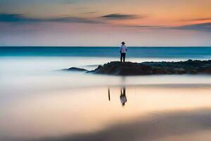 a man stands on a rock in the ocean at sunset. AI-Generated photo