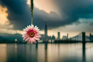 a flower hanging from a string in front of a city. AI-Generated photo