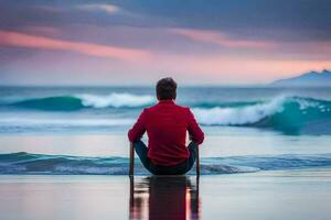 un hombre sentado en un playa en frente de un puesta de sol. generado por ai foto