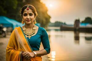 a beautiful indian woman in a sari standing by the water. AI-Generated photo