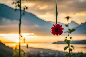 a red flower hanging from a rope in front of a mountain. AI-Generated photo