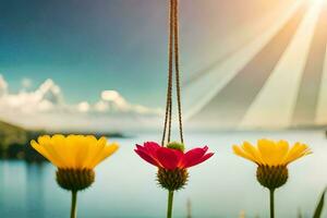 three flowers hanging from a string with a lake in the background. AI-Generated photo