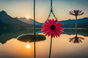 a pink flower hanging from a chain in front of a lake. AI-Generated photo