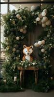 Whimsical woodland theme with animal decor and greenery garland photo