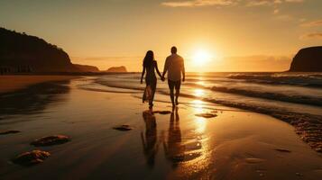 Couple walking hand-in-hand on a beach at sunset photo