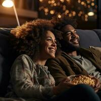 Woman cuddles with man while watching a movie. photo