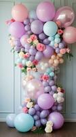 Pastel balloon garland with flowers and greenery photo