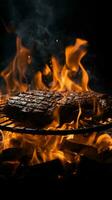 Grill inferno, Black backdrop with a blazing fire on the barbecue Vertical Mobile Wallpaper AI Generated photo