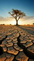 Tree on cracked ground signifies climate change impact, drought, and environmental crisis Vertical Mobile Wallpaper AI Generated photo