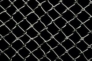 Chain link mesh fence design in sharp contrast on black AI Generated photo