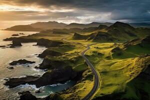 A scenic coastal road meandering along the ocean, captured from above photo