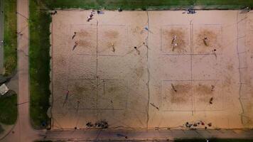 Summer beach volleyball courts with people playing on a summer night video