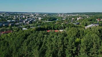 Aerial camera view on the forest and the stadium. View of the football field and athletics stadium. View of the city and downtown video