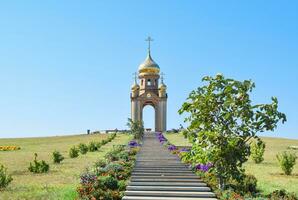 Orthodox chapel on a hill. Tabernacle in the Cossack village of Ataman. The stairs leading to the chapel photo