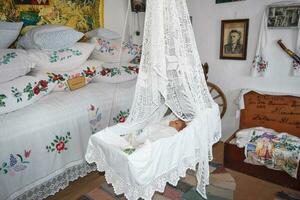 Cradle with dolls in the bedroom photo