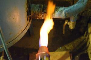 Heating a steel pipe with a blowtorch. The flame of a blowtorch photo