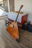 Balalaika-contrabass under a canopy in a cottage photo