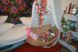 Cradle with dolls in the bedroom photo