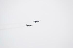 Air show in the sky above the Krasnodar airport flight school. Airshow in honor of Defender of the Fatherland. MiG-29 in the sky. photo