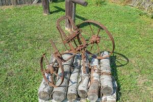 The old iron plow for digging the garden photo