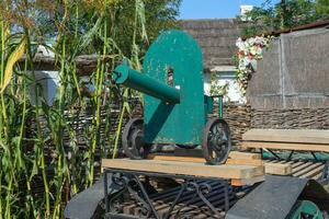 Green fake ancient gun on a cart photo