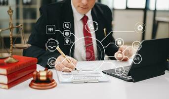 justice and law concept. Male judge in a courtroom he gavel, working with smart phone and laptop and digital tablet on white table with VR icon photo