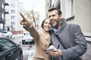 Portrait of happy couple on city trip photo