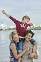 Germany, Duesseldorf, happy family with daughter at Rhine riverbank photo