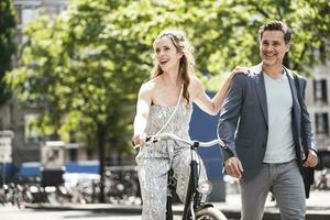 Happy couple with bicycle in the city photo
