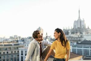 Happy young couple above the city, Milan, Italy photo