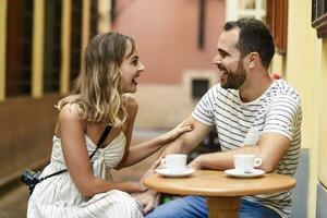 Spain, Andalusia, Malaga, happy couple having a coffee in an alley photo