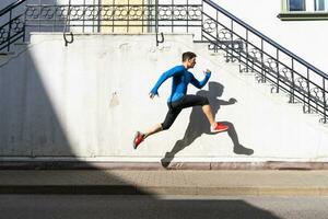 Sportive man exercising on pavement photo