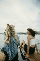 Happy female friends on a boat trip on a lake photo