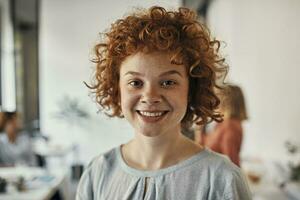 Portrait of a smiling redheaded businesswoman in office photo