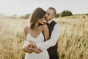Couple embracing each other at field on sunny day photo