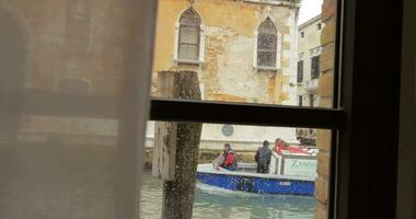 Boat with cargo sailing on canal in Venice video